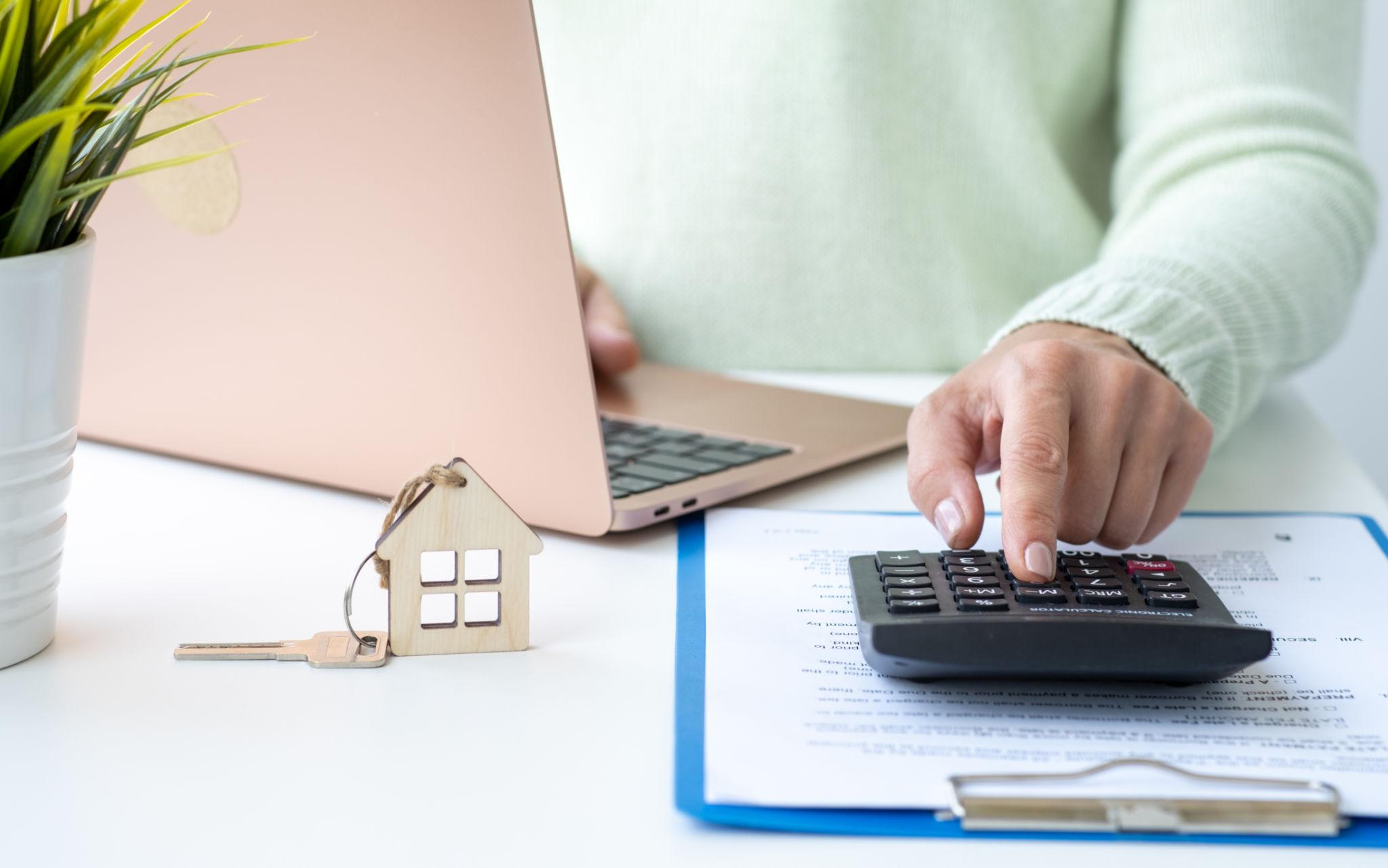 Mortgage refinance paperwork and calculator for homeowners exploring refinancing options